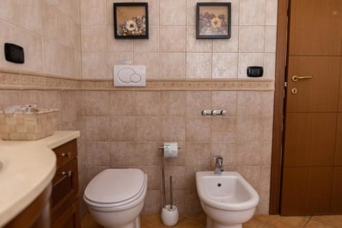 Bathroom in Mas Collection's San Bartolomeo Superior Double Room in Bari, Italy, featuring toilet, bidet, and sink.