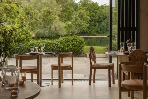 Terrasse extérieure du Moulin Moulin B&B à Dannes avec vue sur la rivière, mobilier en bois et espace repas