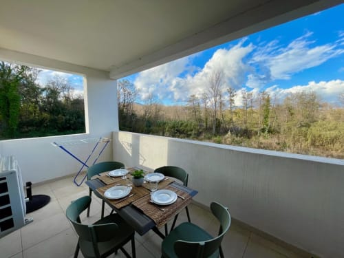Balcony dining area at Résidence Marina di Bravone with forest and mountain views, Linguizzetta