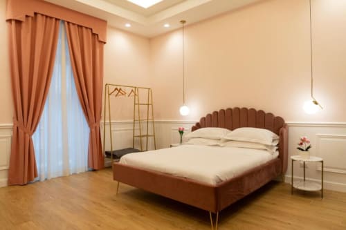 Modern Pink Room bedroom with terracotta velvet bed, coral curtains, and wooden flooring at Mas Collection, Bari