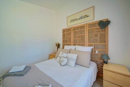 Chambre douillette du Domaine Bellavigne Gîtes et Spa à Forcalquier avec tête de lit tissée et literie neutre