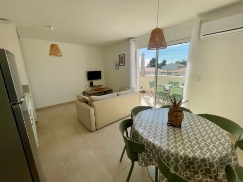Modern apartment at Marina di Bravone with dining area, living room, kitchen, and beachfront balcony view