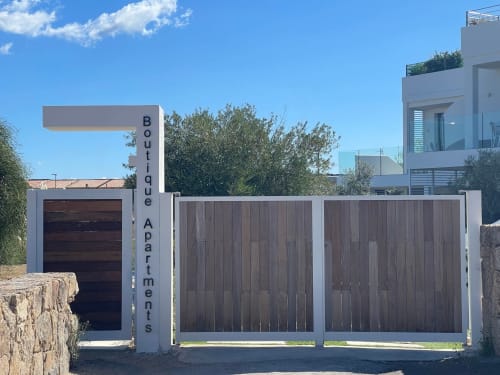 Like at Home Palau boutique apartments entrance with modern garage and wooden gates in Palau, Sardinia
