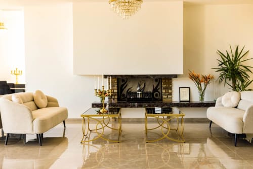 Elegant living room at Hôtel Villa Martini in Ajaccio with cream sofas, gold chandeliers, and marble floors