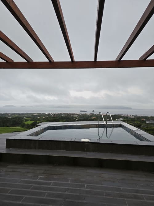 Infinity pool with sea view at Adega da Quinta villa in Madalena, overlooking coastal landscape
