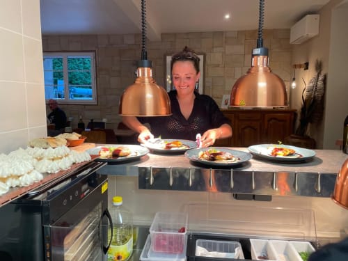 Chef plating colorful dishes at Clos De La Gourmandiere kitchen in Saint-Lothain, France