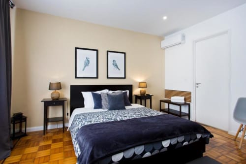 Bright Family Room at Cem Contos B&B in Porto with queen bed, hardwood floors, navy bedding, and cream walls