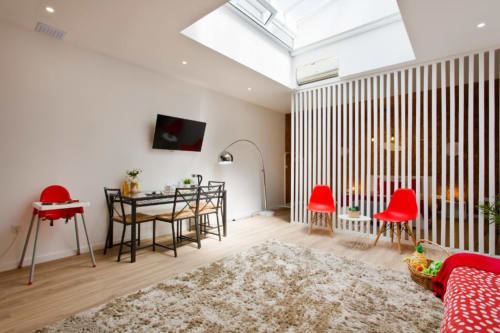 Modern Family Studio at Cem Contos Porto with red chairs, skylight, dining table, and play area