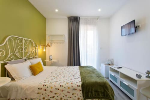 Double room with terrace at Cem Contos B&B in Porto, featuring olive green accent wall, ornate headboard, and modern