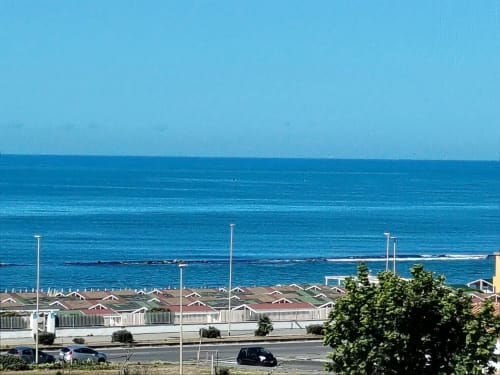 ViOletta hotel overlooking blue ocean with beach cabanas and parking in Roma