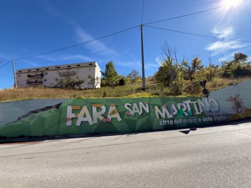 Cartello di benvenuto di Fara San Martino con edificio residenziale sulla collina, Atessa Italia