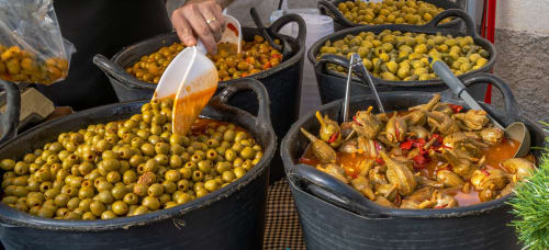 Large pots of marinated olives and stewed vegetables at Complejo Turístico Retiro del Teatro in Almagro, Ciudad Real