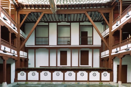 Historic courtyard of Teatro Retiro inn in Almagro with timber-framed colonial architecture and decorative wooden details