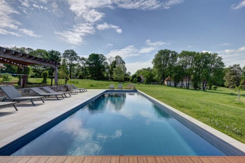 Luxury poolside at Domaine Des Forges De La Vache, Raveau, with loungers and pastoral views