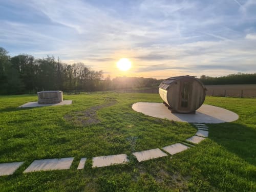 Barrel-shaped cottage at Domaine Des Forges De La Vache in Raveau, France, sunset countryside setting