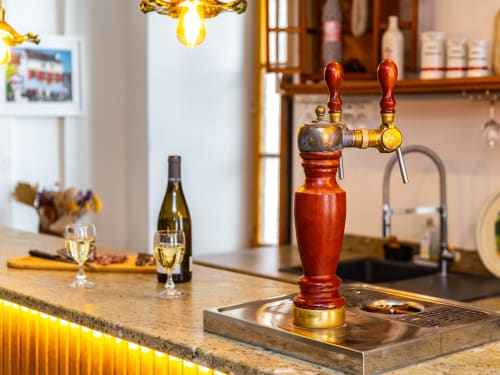 Beer taps at La Maison George bar, Flavigny sur Ozerain, with wine glasses and hospitality setting