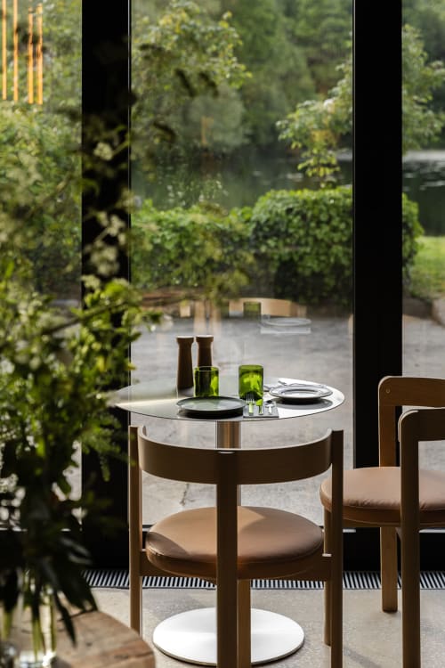 Modern dining table at Moulin Moulin B&B in Dannes with garden views through large windows