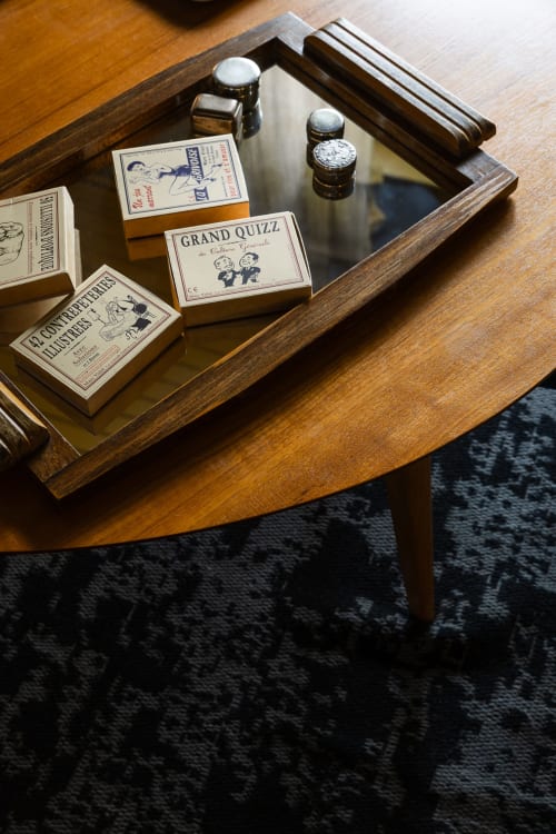Vintage board games and cologne bottles displayed in wooden drawer at Moulin Moulin B&B, Dannes France