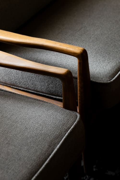 Wooden chair armrests and gray upholstered seat at Moulin Moulin bed and breakfast in Dannes, France