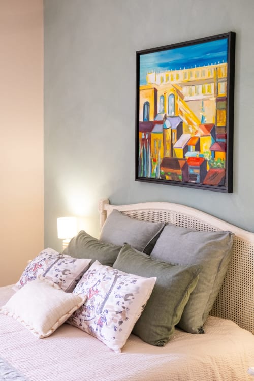 Cozy bedroom at Le Jardin Secret cottage in Grignan with colorful abstract painting above bed and pillows