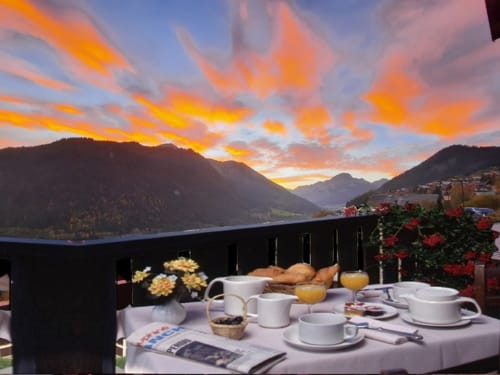 Sunrise breakfast at Hôtel Les Triolets in Châtel with alpine lake and mountain views
