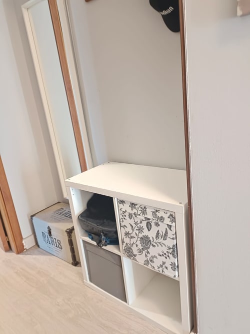 White storage unit with decorative door and open shelves in Tales of Abruzzo apartment, Atessa Italy