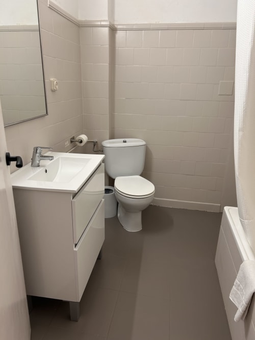 Modern bathroom with sink, toilet, and shower at Hostal Estació in Puigcerdà