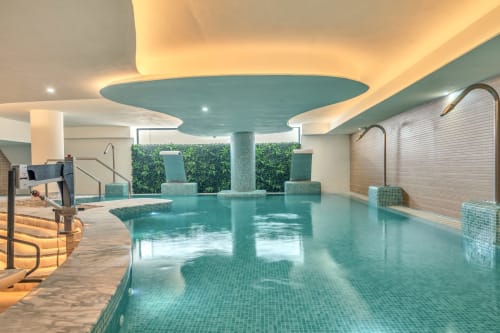 Luxurious indoor swimming pool at HomyMarbella in Elviria with turquoise water, mosaic tiles, and modern wellness amenities