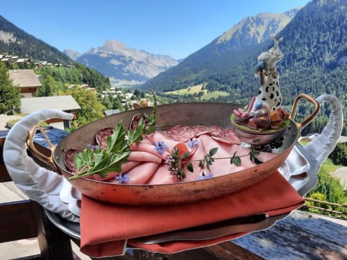 Charcuterie charcuterie platter overlooking Alpine mountains at Hôtel Les Triolets in Châtel
