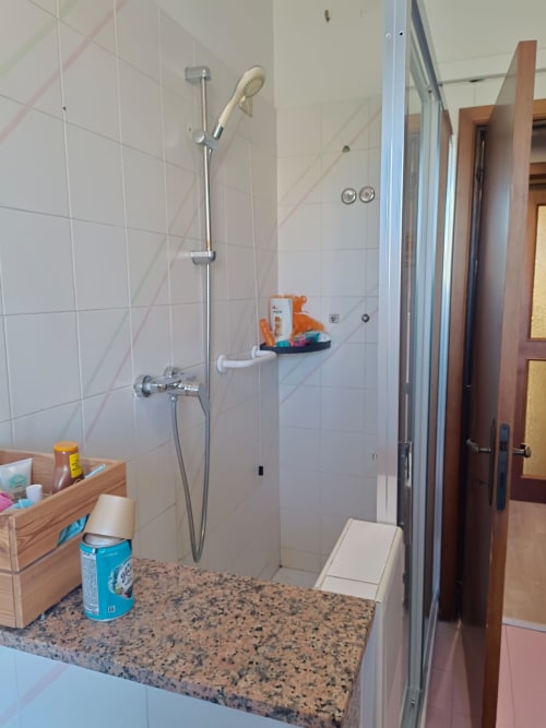 Modern shower enclosure with rainfall showerhead and sliding glass doors in Residenza Montemarcone apartment at Tales of
