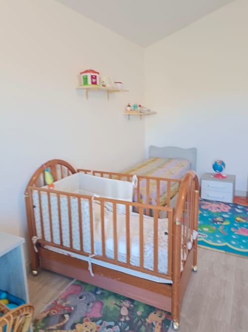 Wooden baby crib with white bedding in apartment nursery, Tales of Abruzzo, Atessa