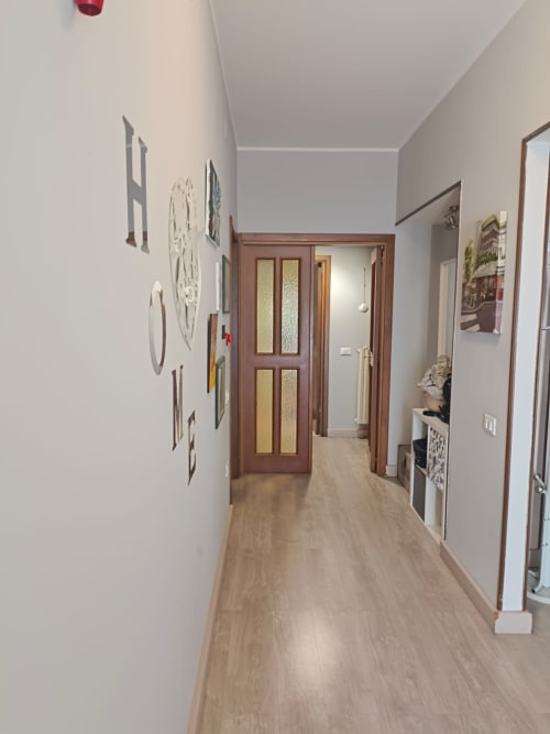 Modern hallway in La Rondine apartment, Tales of Abruzzo, Atessa with wooden doors and light flooring