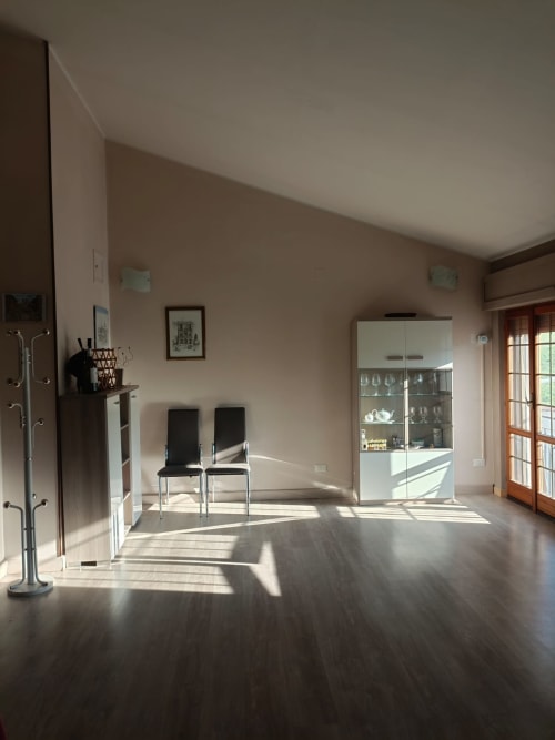 Spacious modern apartment living room at Tales of Abruzzo in Atessa with sunlit hardwood floors and contemporary furnishings