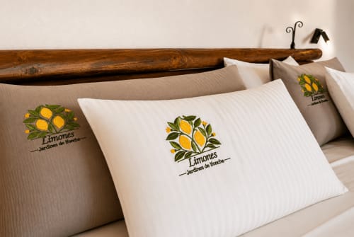 Decorative pillows with lemon embroidery on hotel bed at Jardines de Ifonche, Tenerife