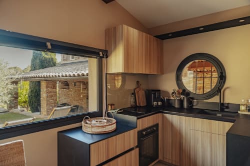 Modern kitchen in Le Mazet Tihou at Mas Tihou B&B, Le Beausset, with wood cabinetry and garden view