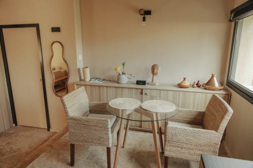 Cozy seating area in Le mazet Tihou room at Mas Tihou B&B, Le Beausset, with woven chairs and garden view