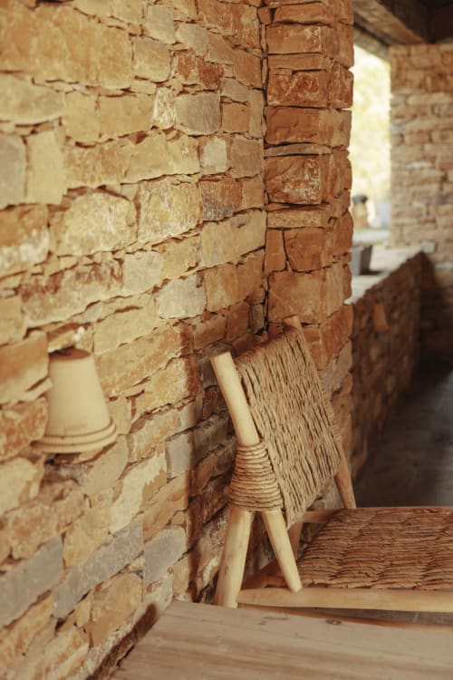 Rustic brick archway with wooden furniture at Mas Tihou bed and breakfast in Le Beausset, France