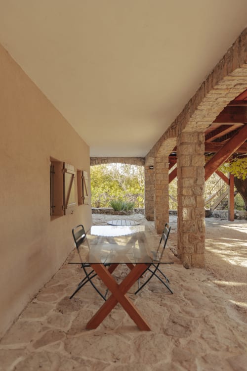 Covered terrace with dining table at Mas Tihou B&B in Le Beausset, overlooking garden and countryside