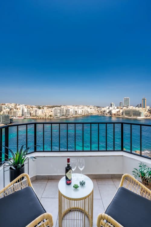 Luxury balcony overlooking turquoise Mediterranean waters at Calm Holiday Homes in Marsaxlokk, Malta