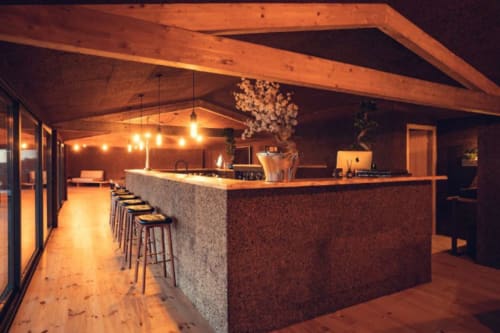 Modern bar counter with wooden beams and stone facade at Charm Nature boutique hotel in Azóia, Portugal
