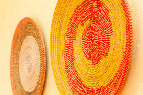 Colorful woven baskets with red and yellow patterns at Agriturismo Chiai Francesco in Bari Sardo