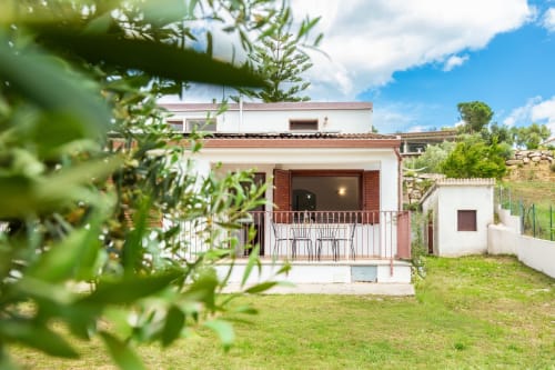 Agriturismo Chiai Francesco B&B in Bari Sardo with terrace, green lawn, and rustic architecture