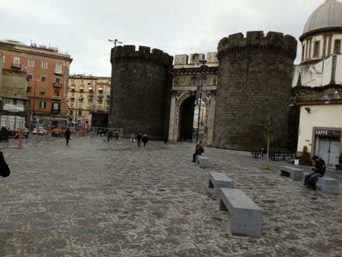 Historic medieval gate and towers in Naples, Italy city square near Neapolis Tecnotourist accommodation