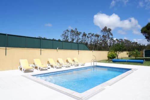 Resort pool with loungers at Be SilverCoast hotel in Serra D'El Rei, Portugal