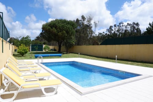 Private pool with yellow loungers and garden at Chalé da Malvarosa villa, Be SilverCoast hotel, Serra D'El Rei