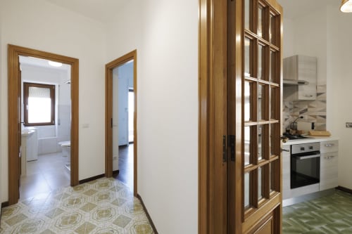 Cucina moderna e corridoio con porte in legno dell'appartamento Profumo di Mare con vista mare presso l'hotel ViOletta, Roma