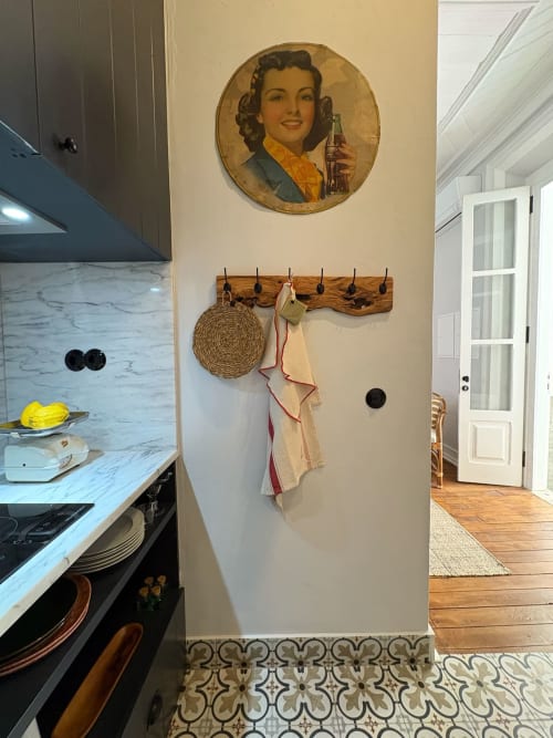 Parede da cozinha com anúncio vintage de Coca-Cola e cabideiro de madeira na Casa Amanhada, Grândola