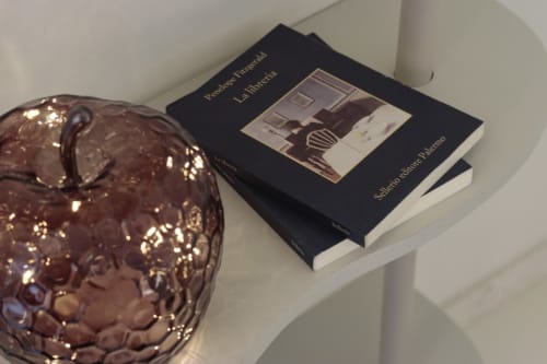 Brown decorative vessel and Italian book on white shelf in Pescara INN Pineta Retreat apartment