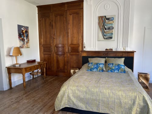 Elegant bedroom at Le Clos Saint Maurin B&B in Saint Maurin with wooden wardrobe, beige bedding, and classic French decor