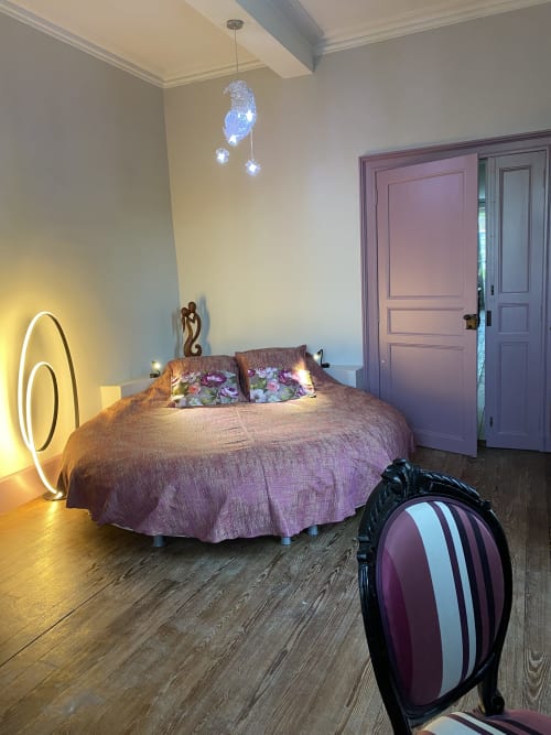 Elegant bedroom at Le Clos Saint Maurin B&B in Saint Maurin with purple bedding, neon accent lighting, and modern decor
